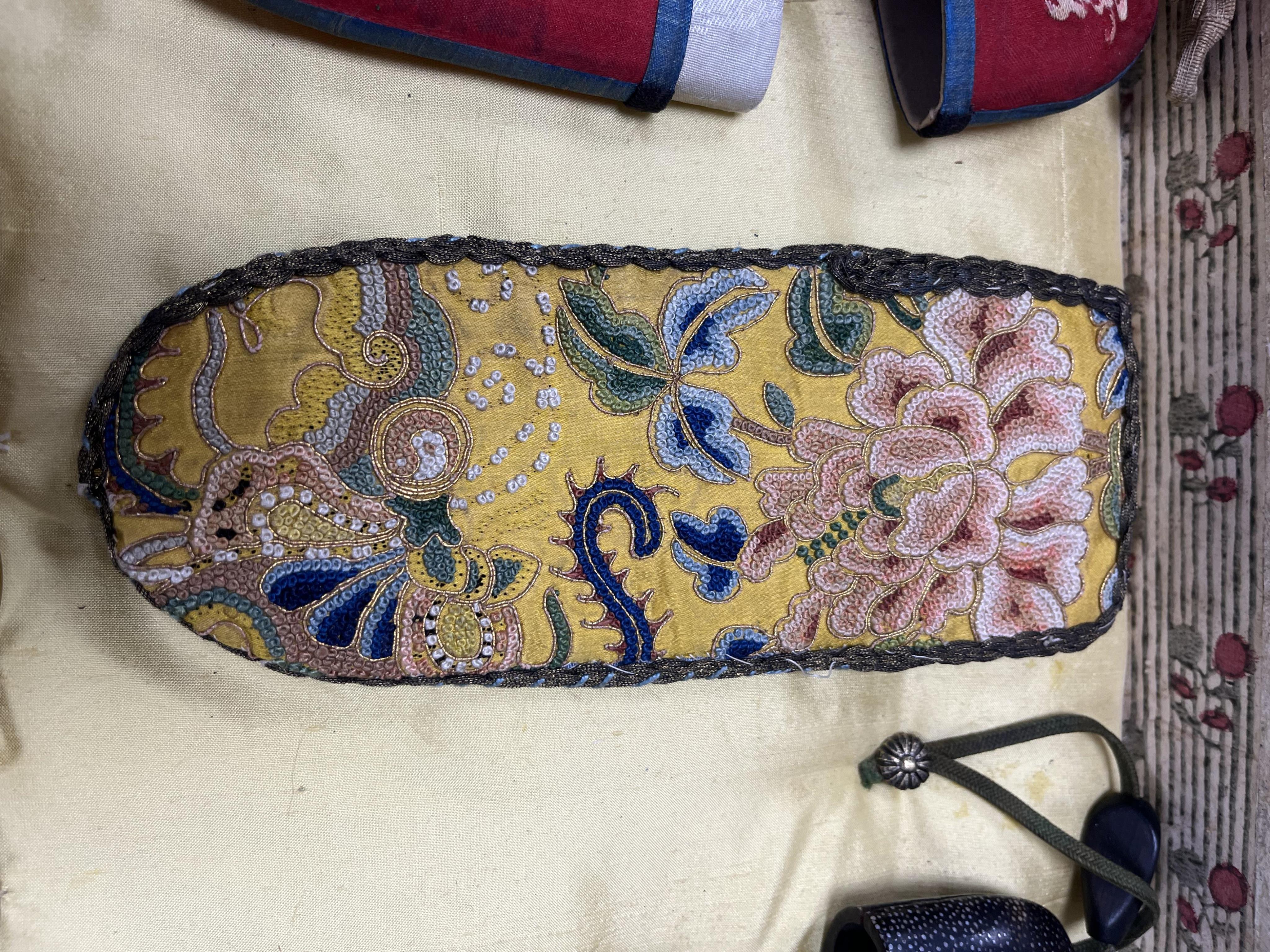 A collection of 19th/20th century Chinese embroidered silk spectacle cases and various spectacles, Box 33cm square